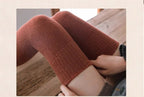A pair of warm Arenzza thigh-high socks long stockings in cozy fabric, extending up the legs for stylish winter wear.