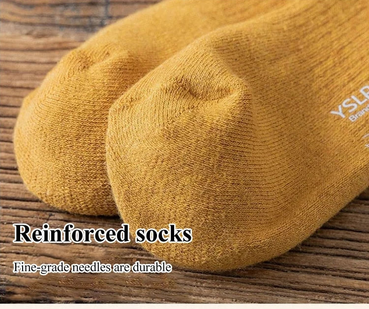 A pair of warm, black thigh-high socks by Arenzza, long stockings extending above the knees, made of soft, cozy material.