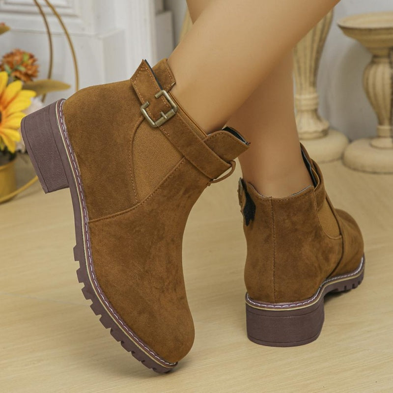 A pair of women's solid black elastic low heel ankle boots by Arenzza, featuring a sleek design and ankle-length fit.
