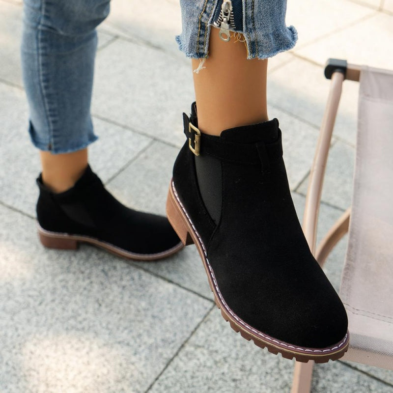 A pair of women's solid elastic low heel ankle boots by Arenzza featuring a sleek design and comfortable fit.