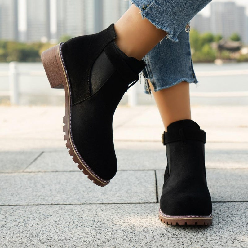A pair of women's solid black elastic low heel ankle boots by Arenzza, featuring a sleek design and ankle-high style.