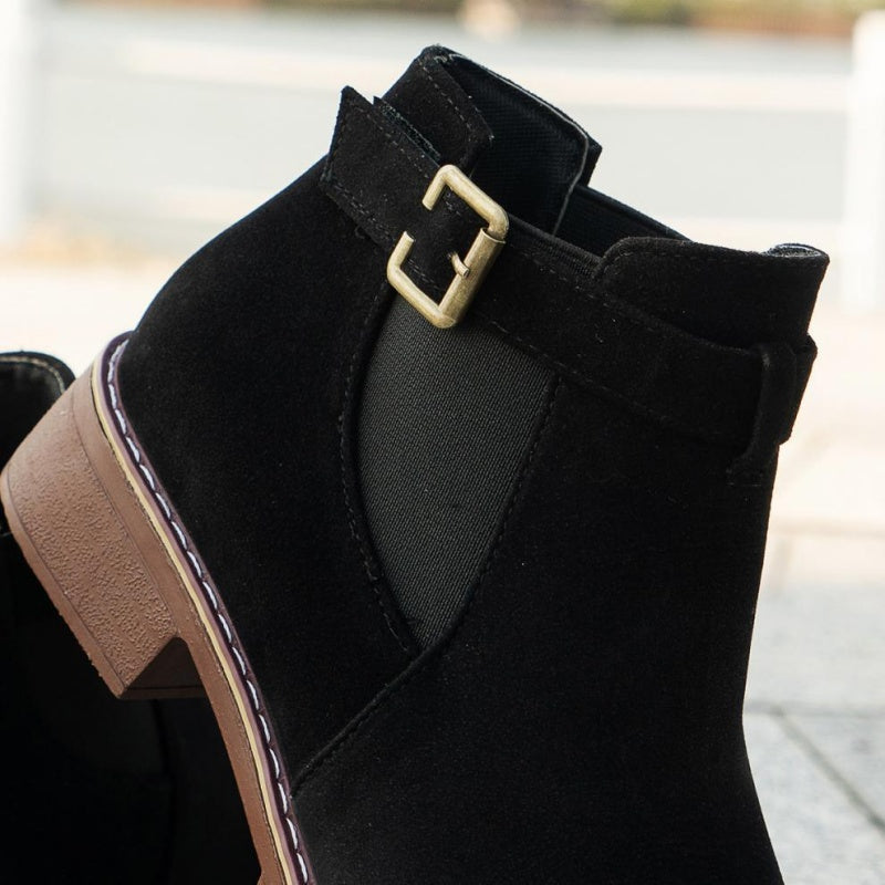 A pair of women's solid black elastic low heel ankle boots by Arenzza, featuring a sleek design and ankle-high cut.