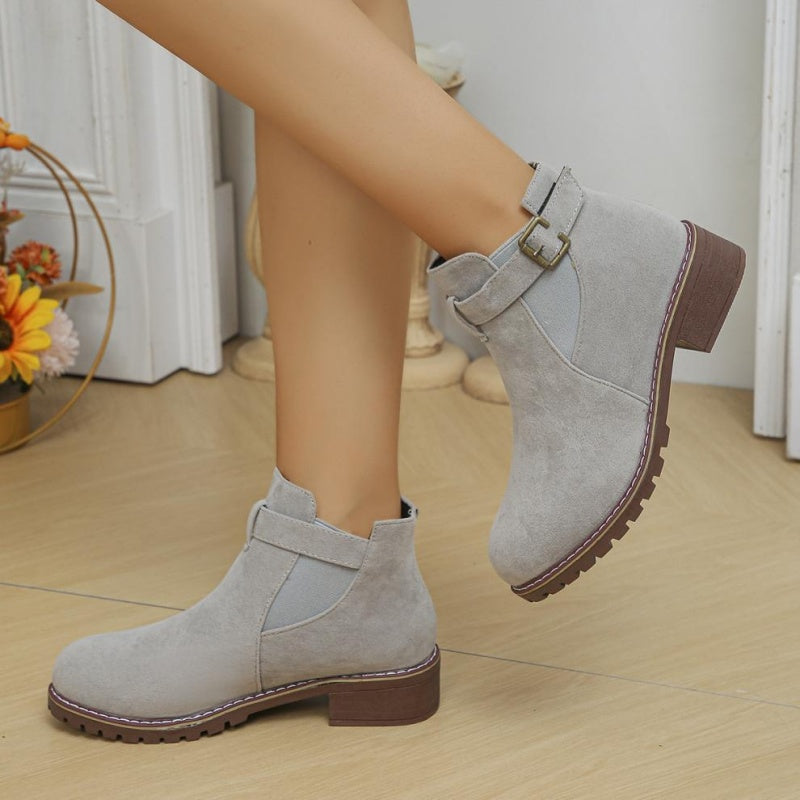 A pair of women's solid black elastic low heel ankle boots by Arenzza, featuring a sleek design and comfortable fit.