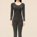 A woman wearing Arenzza thermal underwear set for women, featuring a cozy, fitted top and matching thermal leggings.
