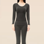 A woman wearing Arenzza thermal underwear set for women, featuring a cozy, fitted top and matching thermal leggings.