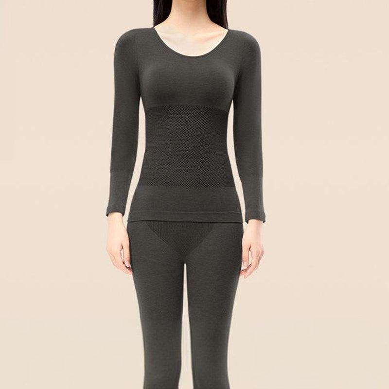 A woman wearing Arenzza thermal underwear set for women, featuring a cozy, fitted top and matching thermal leggings.