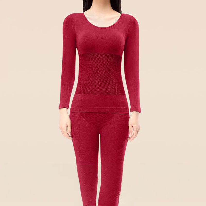 A woman wearing Arenzza thermal underwear set, cozy long-sleeve top and matching leggings for cold weather comfort.