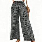 A pair of women's Arenzza wide-leg pants with smocked waist and slit detailing, showcasing stylish and comfortable clothing.