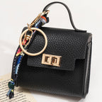 Arenzza mini keychain coin purse in soft fabric with a zipper closure, attached to a keyring for easy carrying and organization.