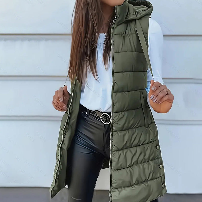 A women’s zip-up long puffer vest by Arenzza, featuring a stylish quilted design and front pockets, perfect for cold weather.