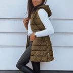 A women’s long puffer vest by Arenzza with a zip-up front, designed for warmth and style, shown in a neutral color.