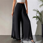 A woman wearing Arenzza women's flowing chiffon wide-leg pants, showcasing their relaxed fit and elegant design.
