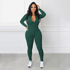 A black solid color half zip seamless jumpsuit from Arenzza, displayed on a mannequin, highlighting its fitted, sleek design.