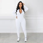A woman wearing a black Arenzza Solid Color Half Zip Seamless Jumpsuit, showing the half-zip collar and form-fitting design.