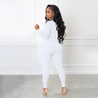 A black Arenzza solid color half zip seamless jumpsuit made of stretchy, form-fitting fabric shown on a hanger.