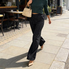 A pair of high-waist glitter straight-leg trousers by Arenzza, featuring a shiny, sparkly fabric and a tailored fit on a hanger.