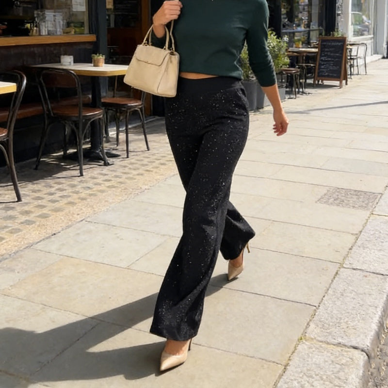 A pair of high-waist glitter straight-leg trousers by Arenzza, featuring a shiny, sparkly fabric and a tailored fit on a hanger.