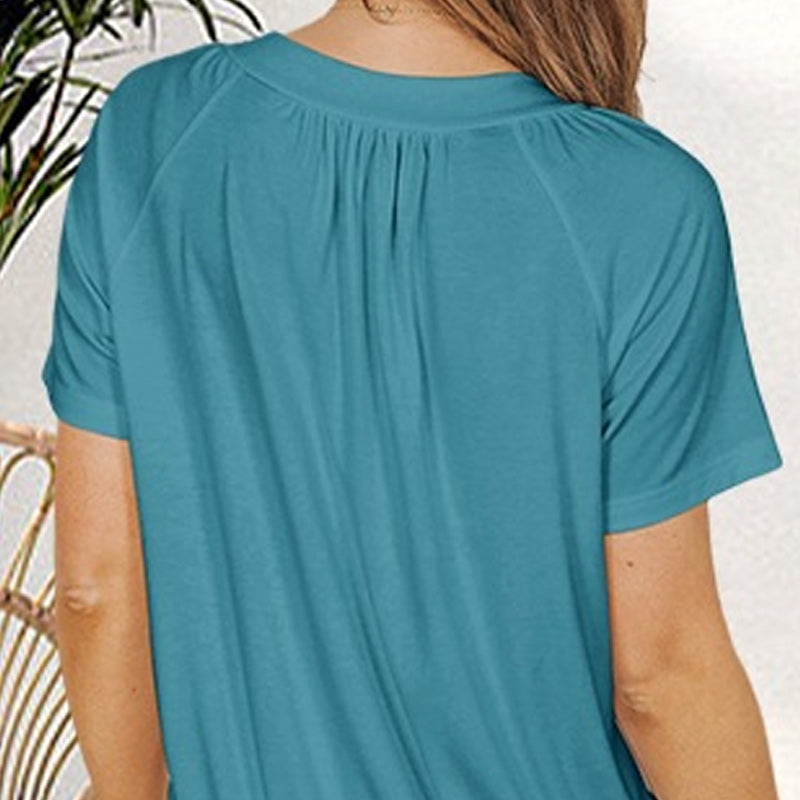 A woman wearing a light blue women's casual pleated V-neck short-sleeve top by Arenzza, styled casually.