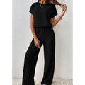 A woman wearing Arenzza's ribbed knit top and wide-leg pants set, showcasing a stylish and comfortable clothing ensemble.