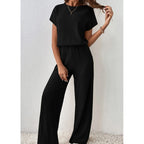 A woman wearing Arenzza's ribbed knit top and wide-leg pants set, showcasing a stylish and comfortable clothing ensemble.