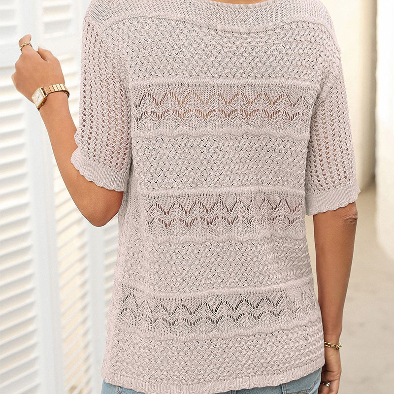 A women's hollow knit crochet short sleeve sweater with a round neckline from Arenzza, showcasing its textured fabric and short sleeves.