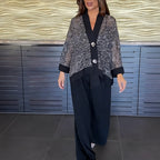 A woman wearing the Arenzza women's V-neck sequin cardigan and wide-leg pants 2-piece set, showcasing the stylish, shimmering outfit.
