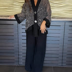 A woman wearing a shiny sequin V-neck cardigan and wide-leg pants from Arenzza, showcasing a stylish two-piece clothing set.