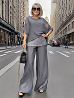 A stylish Arenzza suit, elegant and fashionable, displayed on a hanger with a sleek design and sophisticated appearance.
