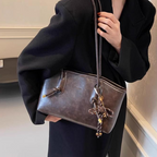 A women's vintage PU leather shoulder bag in black with a classic design, featuring a top handle and shoulder strap.