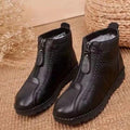 A pair of Arenzza women's winter ankle boots with side zippers, thermal insulation, water-resistant material, shown on a model.