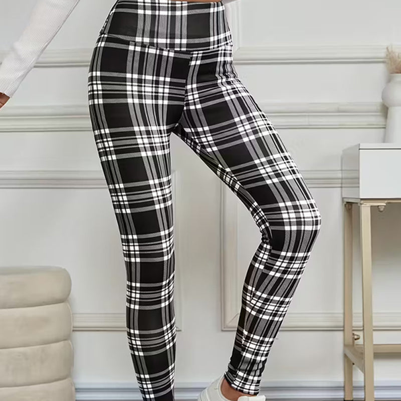 A pair of high-elasticity slim fit warm plaid leggings for women from Arenzza, featuring a cozy winter plaid pattern.