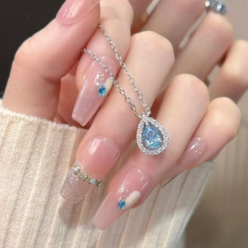 Elegant blue teardrop necklace for women featuring a silver chain and a shimmering blue pendant, stylish jewelry by Arenzza.