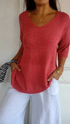 A beige solid color knitted V-neck top by Arenzza, displayed flat with long sleeves and ribbed texture.