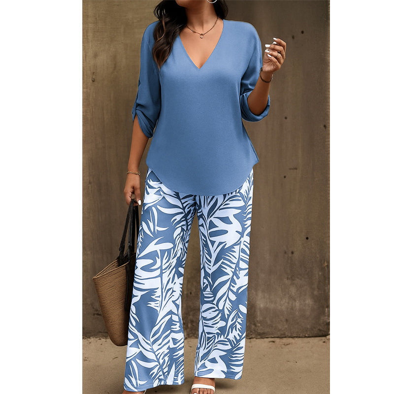 Arenzza women's V-neck blouse and printed wide-leg pants set, stylish clothing ensemble with floral print and flowing fabric.