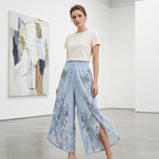 A pair of Arenzza women's floral print high-waist wide-leg pants with a vibrant, colorful floral pattern and flowing wide-leg design.