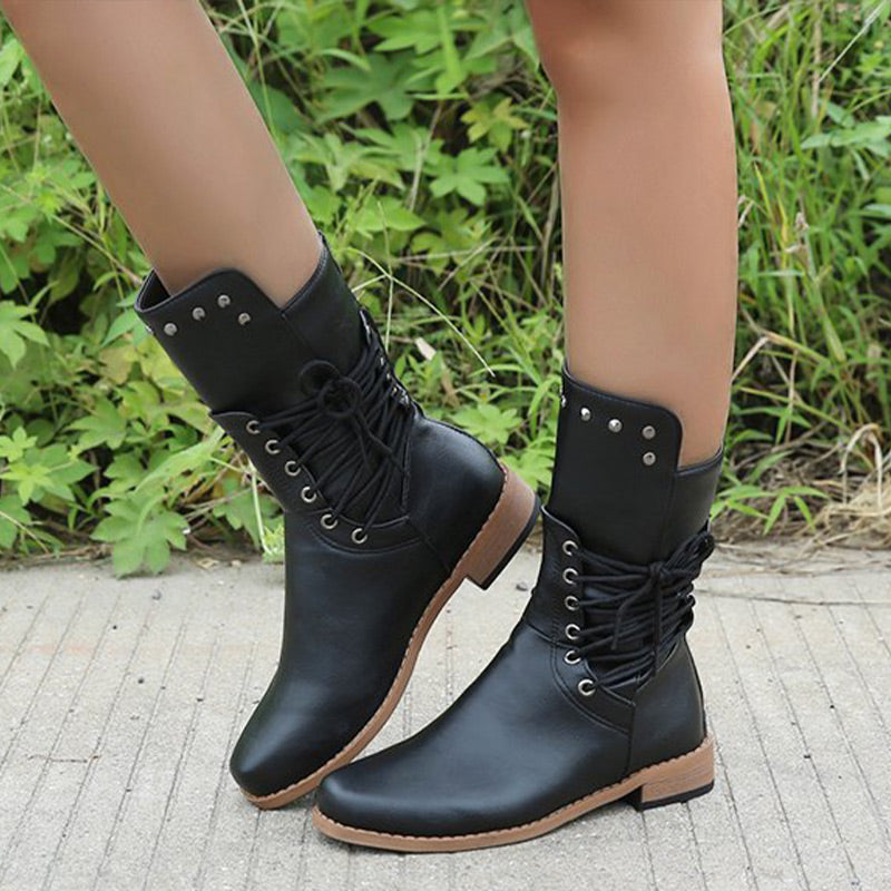 A pair of Arenzza women's lace-up low-heel ankle boots with round toes in black leather, featuring stylish design details.