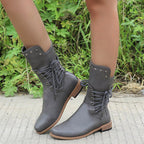 A pair of Arenzza women’s lace-up low-heel ankle boots with round toes in black leather, stylish and versatile footwear.