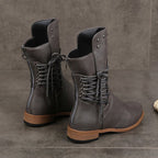A pair of Arenzza women’s lace-up low-heel ankle boots with round toes, made of black leather, stylish and comfortable footwear.