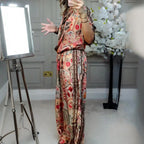 Arenzza women's printed top and wide-leg pants 2-piece set displayed on a hanger, showcasing stylish, colorful floral print clothing.