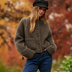 A beige Arenzza CozyElegance knit cardigan with a relaxed fit and ribbed cuffs, perfect for casual warm layering.