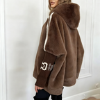 A women’s mink fur hooded zip-up coat by Arenzza featuring plush warmth and casual winter style, shown on a model.