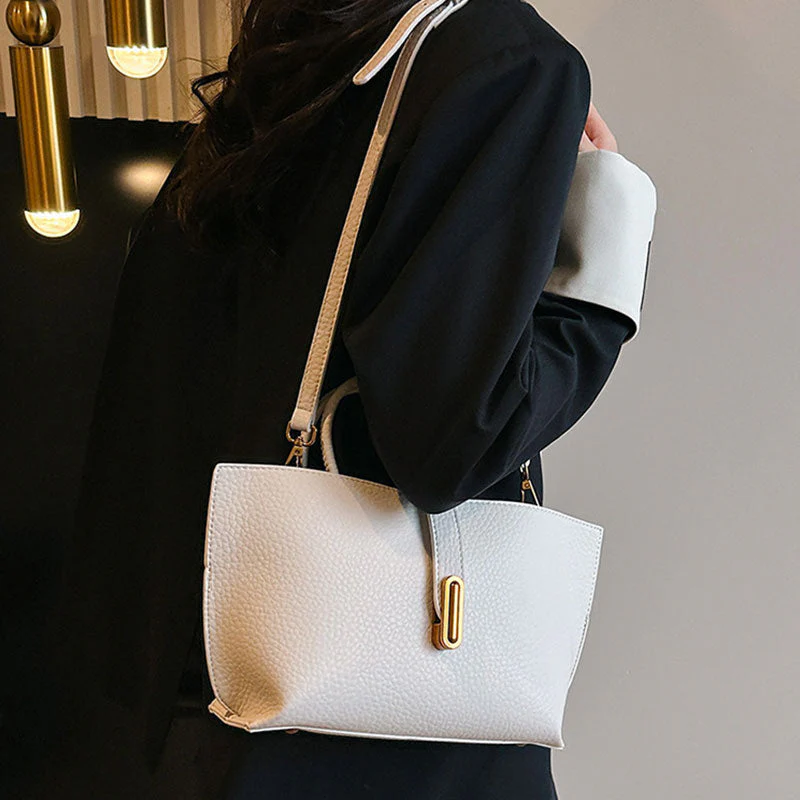 Aarenza women's elegant solid color French style handbag with gold-tone hardware, featuring a structured design and top handle.