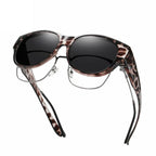 A pair of oversized cat eye sunglasses by Arenzza with polarized UV400 protection, featuring bold black frames and dark lenses.