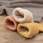 A pair of Arenzza winter thermal socks with a cozy, snug design in warm colors, ideal for cold weather wear.