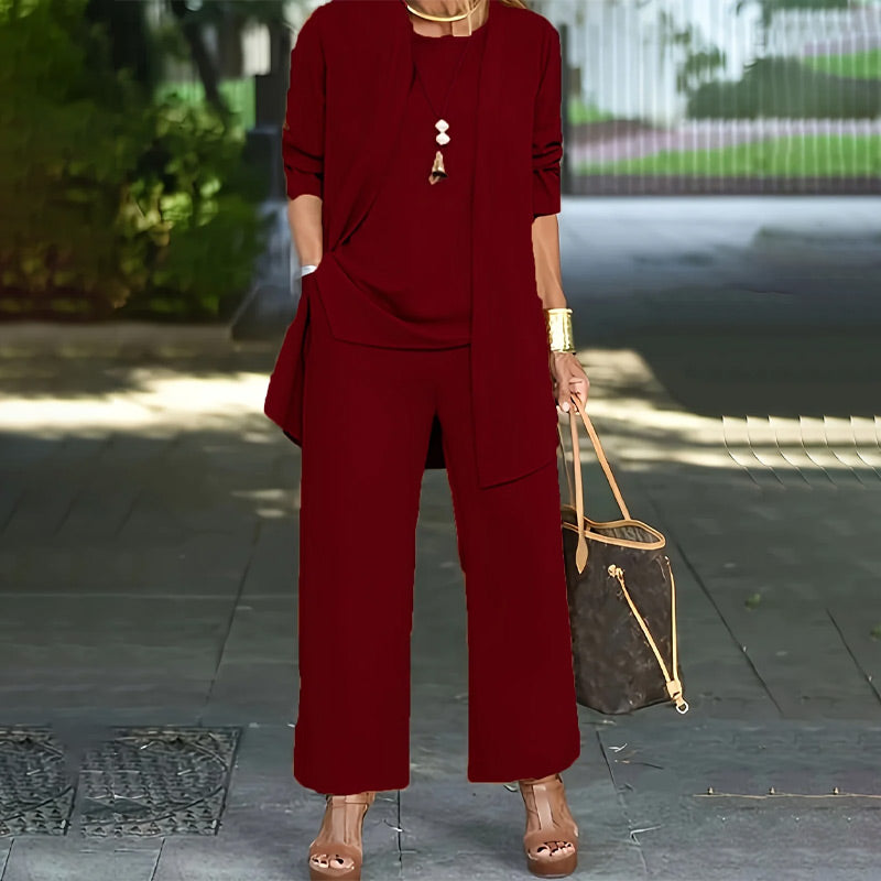 A woman wearing the Arenzza three-piece relaxed fit women’s clothing set with wide-leg pants, cardigan, and top in luxe stretch fabric.