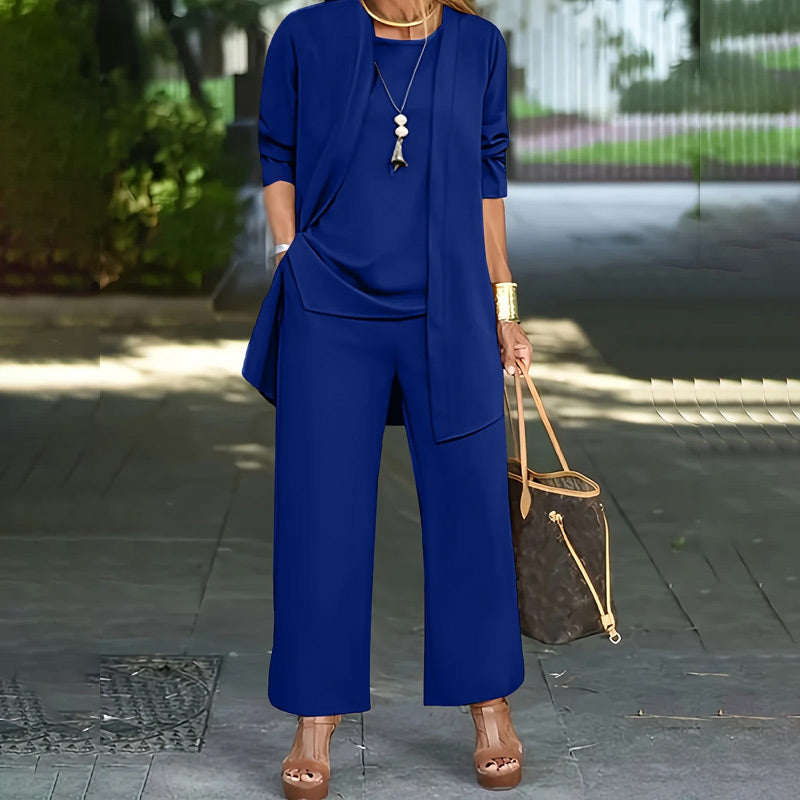 A woman wearing a relaxed fit 3-piece clothing set by Arenzza, featuring wide-leg pants, cardigan, and top in luxe stretch fabric.