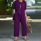 A woman wearing a beige relaxed fit 3-piece set with wide-leg pants, cardigan, and top in luxe stretch fabric by Arenzza.