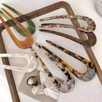 A pair of U-shaped Arenzza women’s hairpins and hair clips with a sleek, minimal design for hair styling and accessories.