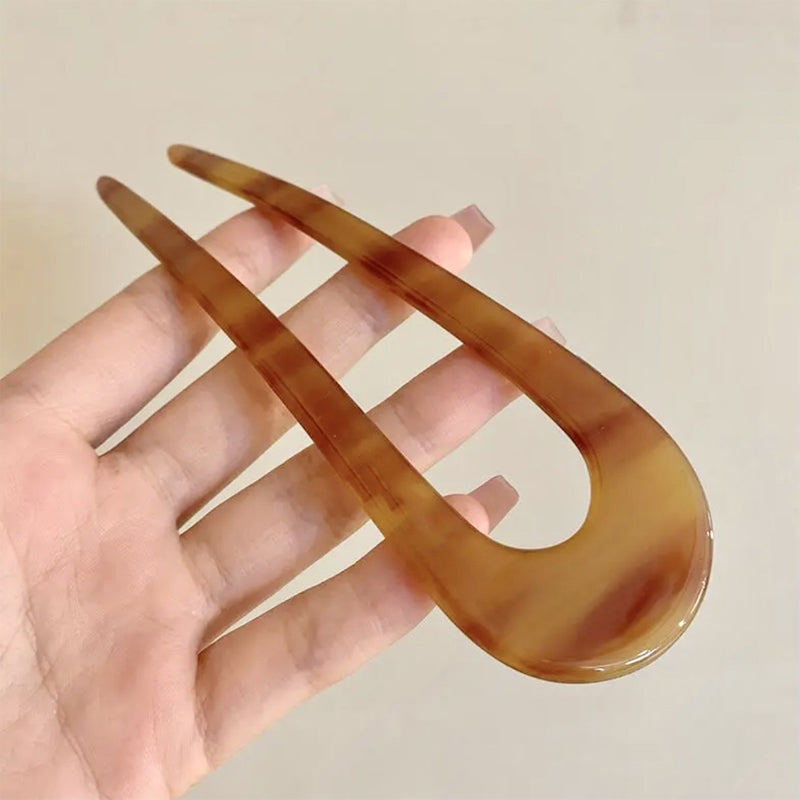 A pair of U-shaped Arenzza women’s hairpins and hair clips with sleek, minimalist design on a neutral background.