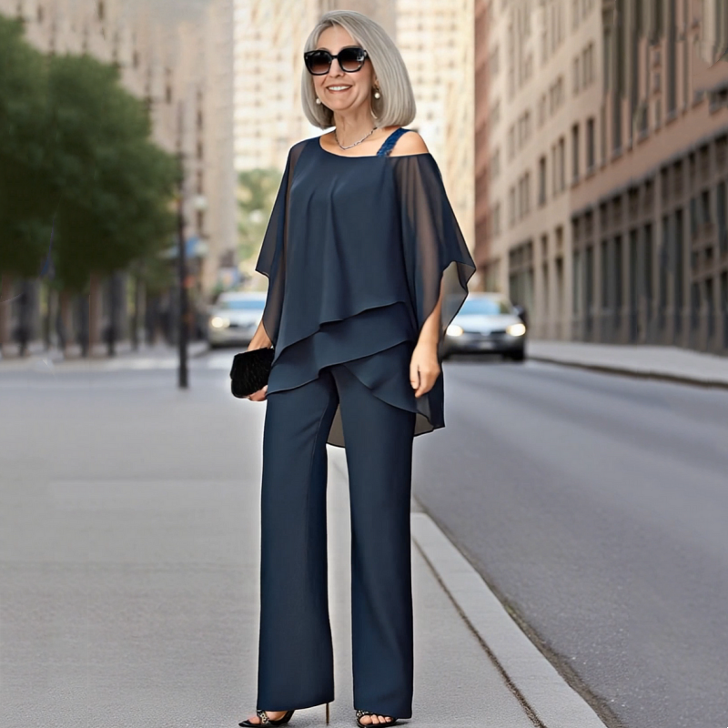 A woman wearing an Arenzza women's two-piece set with an irregular chiffon top and wide-leg pants, stylish and flowy clothing.